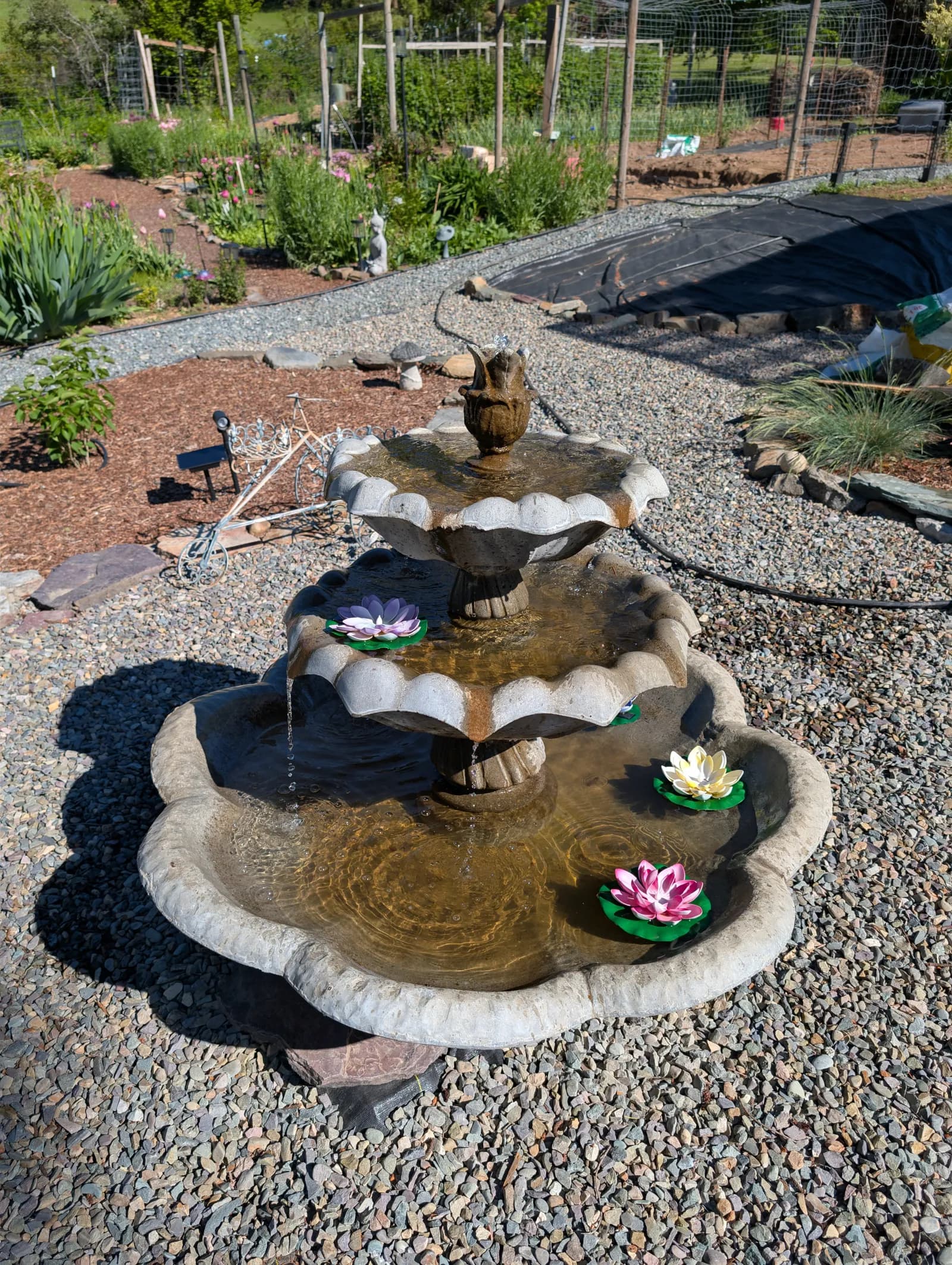 A stone water fountain in the garden